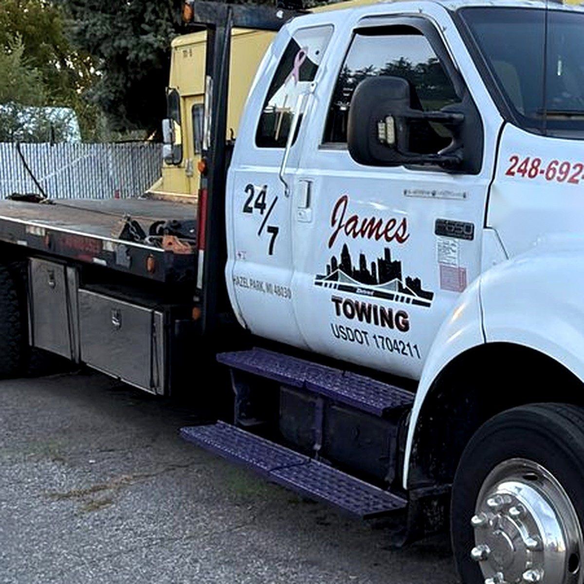 James Towing logo and 24/7 on the door of the white flatbed